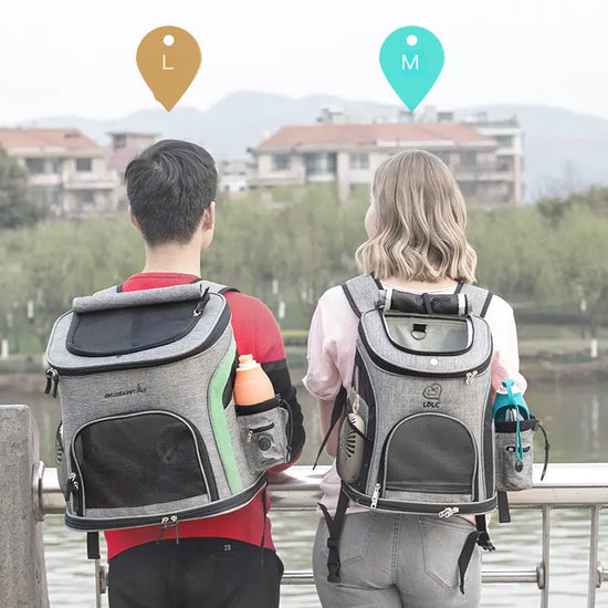 Man and woman outdoors wearing large and medium gray pet carrier backpacks