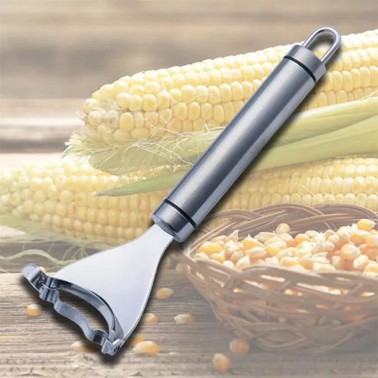 Stainless steel corn peeler tool with fresh corn cobs and corn kernels in a basket