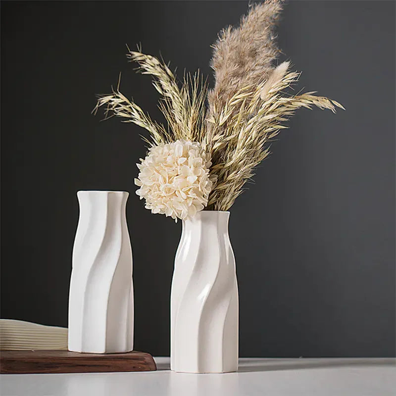 Modern ceramic vase with dried pampas grass and flower on minimalist table