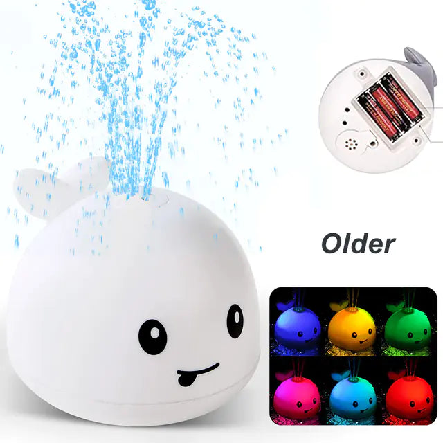 Cute whale bath toy spraying water, battery operated, with multicolor LED lights.