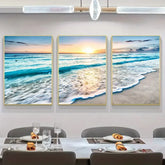 Modern dining room with three-panel ocean sunset wall art and elegant table setting