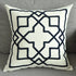 Modern decorative throw pillow with black geometric pattern on a light fabric on gray sofa