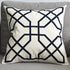 Modern decorative throw pillow with geometric black pattern on white fabric on grey sofa