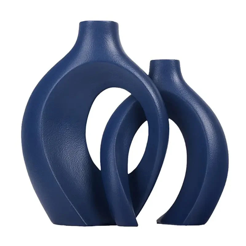Modern navy blue ceramic vases with abstract, curved openwork design