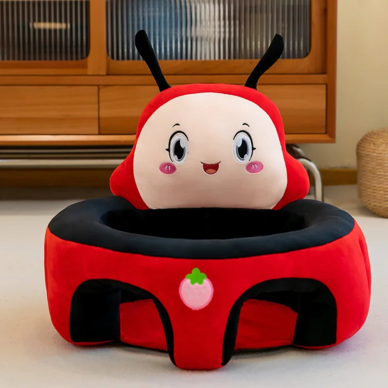 Red and black ladybug plush baby seat with smiling face and strawberry detail