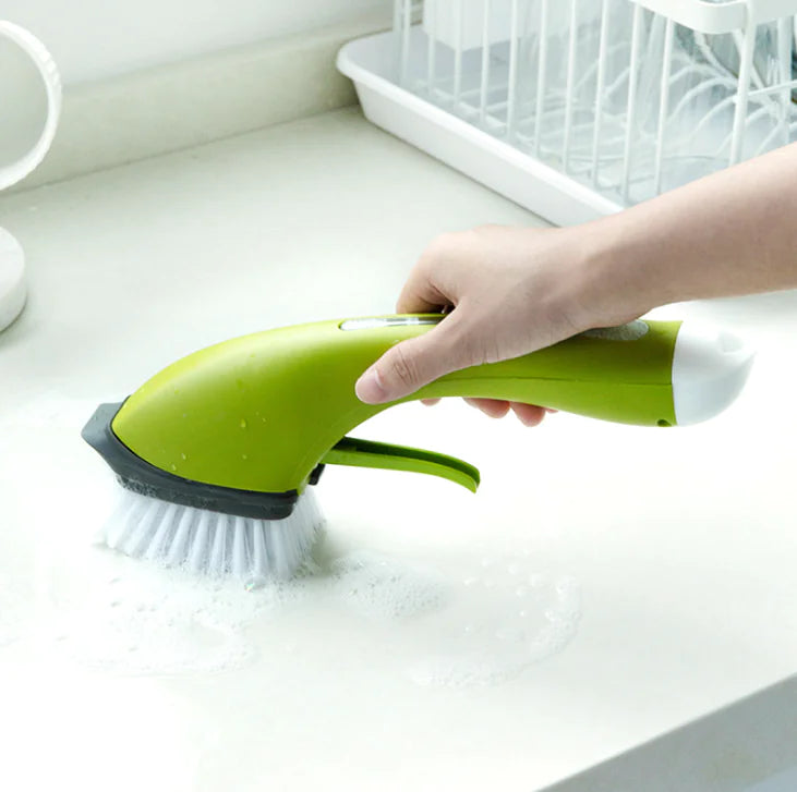 Hand using green dish brush with soap on kitchen counter near dish rack
