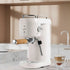 Modern white espresso coffee machine with wooden handle on kitchen counter, latte beside it