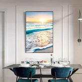 Modern dining room with blue chairs and a large ocean sunset wall art above the table