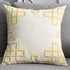 Cream throw pillow with yellow geometric pattern on a gray sofa