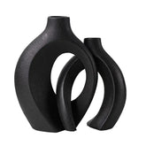 Modern black ceramic vases with abstract geometric design on white background