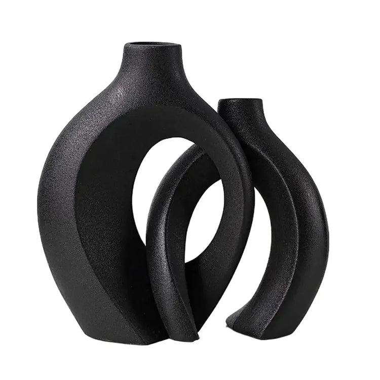 Modern black ceramic vases with abstract geometric design on white background