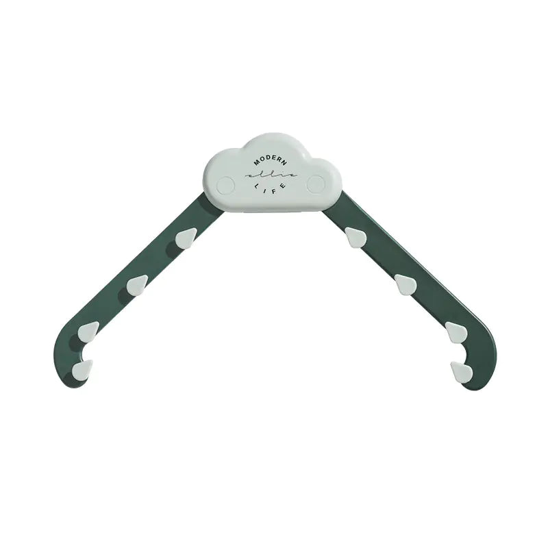 Cloud-shaped plastic clothes hanger with green arms and white hooks, Modern Life text