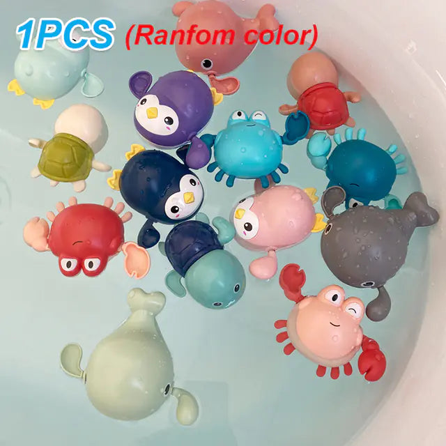Assorted animal bath toys floating in water, including crabs, penguins, turtles, and whales