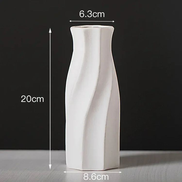 White ceramic vase with twisted design, 20cm tall, 6.3cm top, 8.6cm base, on grey surface