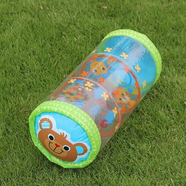 Inflatable baby play tunnel with bear face and flower design on green grass outdoors