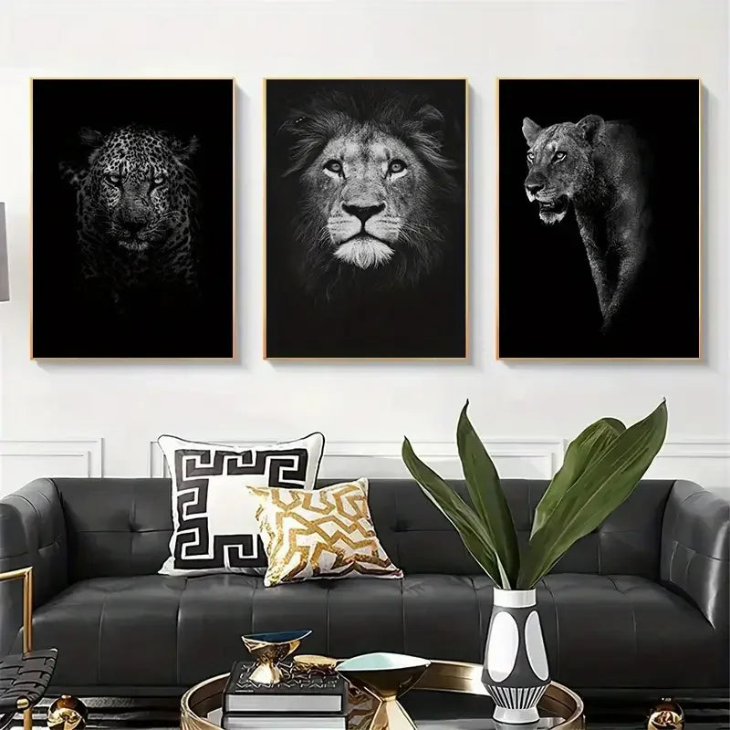 Modern living room with black sofa, gold accents, and wall art of leopard, lion, and lioness portraits