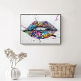 Colorful graffiti lips wall art above white console with vase and wicker basket