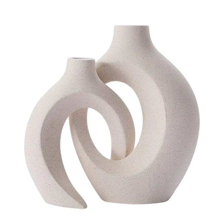 Modern ceramic vases with abstract oval shapes in a light speckled finish