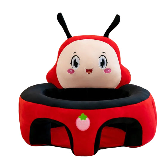 Plush ladybug baby seat with cute face and strawberry patch on red and black fabric