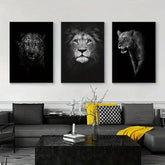 Modern living room with black and white lion, leopard, and lioness wall art above gray sofa