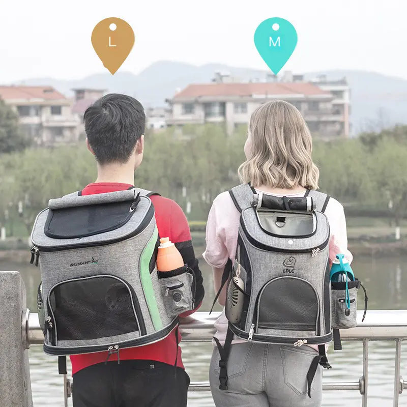 Man and woman outdoors wearing large and medium gray pet carrier backpacks